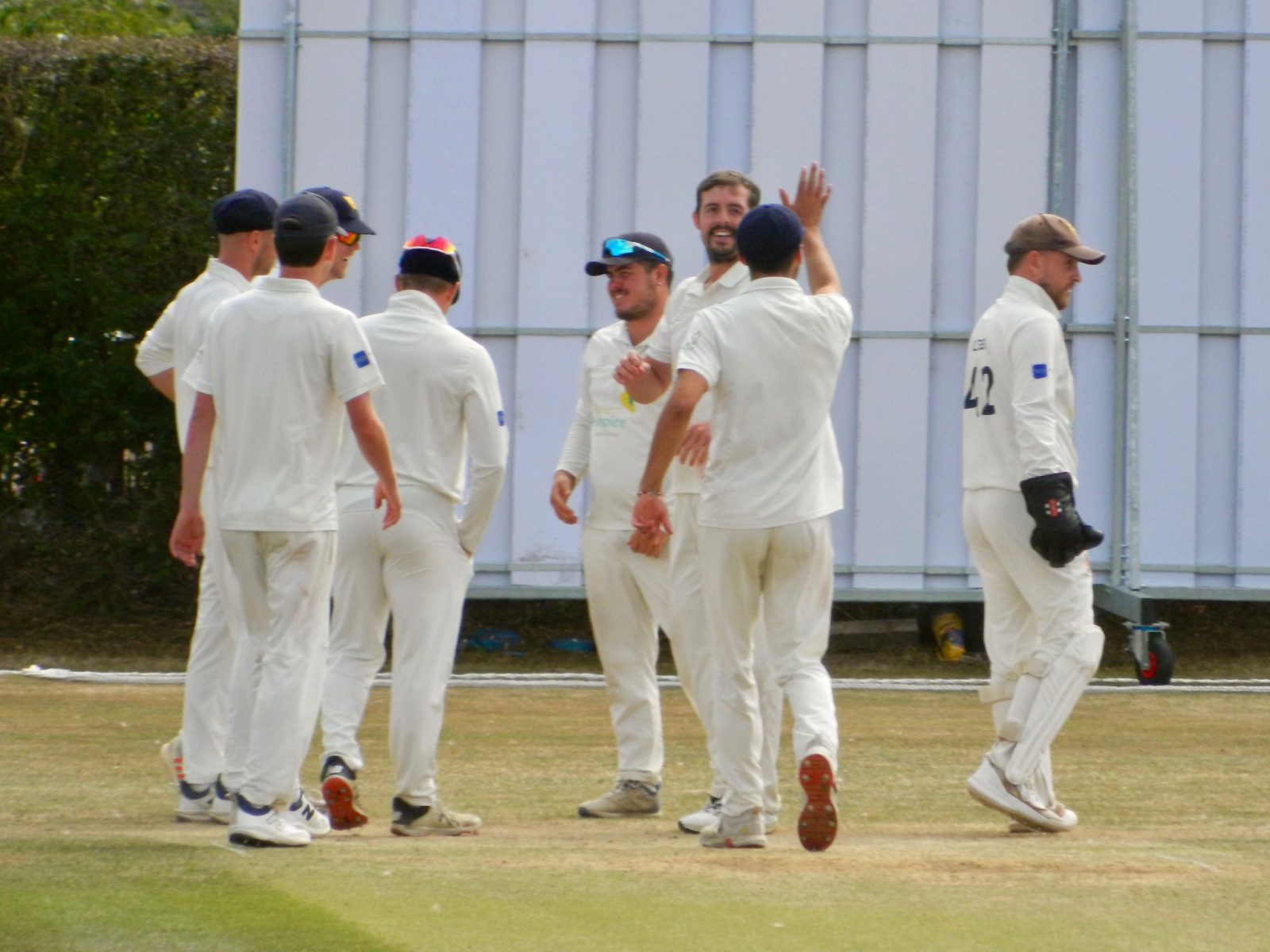 Roman Walker celebrates taking one of his seven wickets in Cheshire's first innings at Nantwich